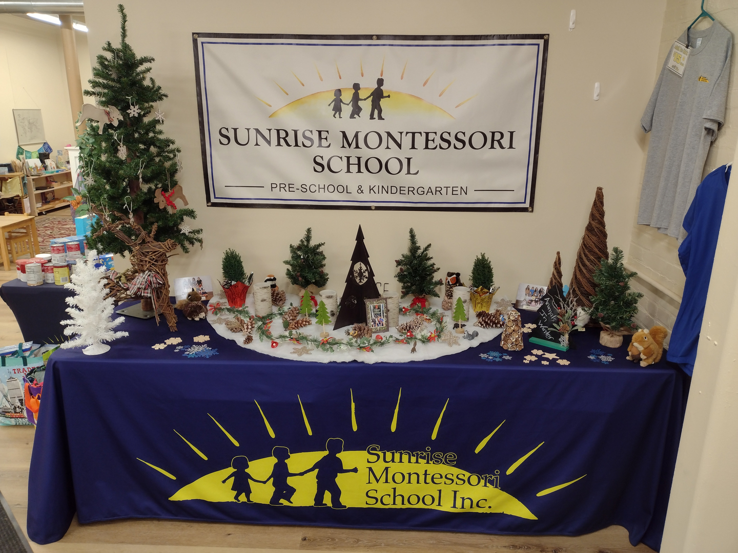 Sunrise Montessori School holiday display table with school banner